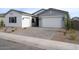 Charming home with a two-car garage, a one-car garage, and a paved driveway, offering ample parking space at 3909 E Gold Mountain Ave, San Tan Valley, AZ 85143