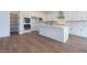 Bright kitchen with an island, white cabinets, stainless appliances, and a spacious walk in pantry at 3909 E Gold Mountain Ave, San Tan Valley, AZ 85143