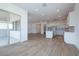 Open-concept floorplan boasts recessed lighting and wood-look tile flooring, seamlessly connecting living spaces at 3909 E Gold Mountain Ave, San Tan Valley, AZ 85143