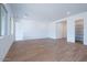 Bright, open living room featuring wood-look tile flooring and neutral walls at 3909 E Gold Mountain Ave, San Tan Valley, AZ 85143