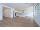 Spacious living area with open layout to kitchen, and wood-look tile flooring at 3909 E Gold Mountain Ave, San Tan Valley, AZ 85143
