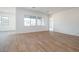 Neutral living space features wood-look tile flooring and large windows, offering bright, natural light at 3909 E Gold Mountain Ave, San Tan Valley, AZ 85143
