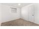 Small bedroom with a ceiling fan, carpet, and a window providing natural light at 6414 W Osborn Rd, Phoenix, AZ 85033