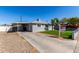 Traditional home featuring a covered carport and well-kept landscaping with a spacious driveway at 6414 W Osborn Rd, Phoenix, AZ 85033