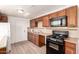 Cozy kitchen featuring wood cabinets, modern appliances, and countertops at 6414 W Osborn Rd, Phoenix, AZ 85033