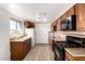 Cozy kitchen featuring wood cabinets, modern appliances, and countertops at 6414 W Osborn Rd, Phoenix, AZ 85033