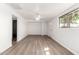 Bright, airy living room featuring modern flooring, fresh paint, and a ceiling fan at 6414 W Osborn Rd, Phoenix, AZ 85033