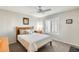 Cozy bedroom with a wooden bed frame and ceiling fan at 9131 W Albert Ln, Peoria, AZ 85382