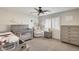 Bedroom features a crib, armchair, and plenty of storage at 9131 W Albert Ln, Peoria, AZ 85382