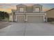 Two-story house with tan exterior, two-car garage, and landscaping at 9131 W Albert Ln, Peoria, AZ 85382