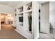 Home hallway with built-in shelving and TV at 9131 W Albert Ln, Peoria, AZ 85382