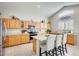 Spacious kitchen with granite countertops and light wood cabinets at 9131 W Albert Ln, Peoria, AZ 85382