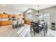 Eat-in kitchen with granite counters, island, and dark wood table at 9131 W Albert Ln, Peoria, AZ 85382