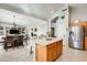 Open kitchen with island, granite countertops, and wood cabinets at 9131 W Albert Ln, Peoria, AZ 85382