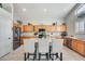 Modern kitchen with wood cabinets, granite countertops, and stainless steel appliances at 9131 W Albert Ln, Peoria, AZ 85382