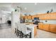 Bright kitchen with an island, granite countertops, and wood cabinets at 9131 W Albert Ln, Peoria, AZ 85382