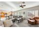 Spacious living room featuring a comfortable sectional sofa and hardwood floors at 9131 W Albert Ln, Peoria, AZ 85382