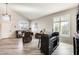 Living area with hardwood floors, a wet bar, and large windows at 9131 W Albert Ln, Peoria, AZ 85382