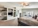 Main bedroom with king-size bed, built-ins and exercise equipment at 9131 W Albert Ln, Peoria, AZ 85382