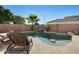 Relaxing pool area with lounge chairs and waterfall at 9131 W Albert Ln, Peoria, AZ 85382