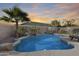 Inviting swimming pool with a waterfall feature and lounge chairs at 9131 W Albert Ln, Peoria, AZ 85382