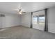 Spacious bedroom with ceiling fan and large window at 12130 N 70Th Ave, Peoria, AZ 85345