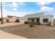 Single-story house with a gray exterior, modern wood accents, and a well-maintained front yard at 12130 N 70Th Ave, Peoria, AZ 85345