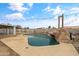 Inviting backyard oasis with a refreshing pool and rock waterfall feature at 12130 N 70Th Ave, Peoria, AZ 85345