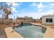 Refreshing backyard pool with a rock waterfall and basketball hoop at 12130 N 70Th Ave, Peoria, AZ 85345