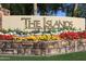 The Islands community entrance, featuring a stone sign and vibrant flowerbeds at 1449 W Iris Dr, Gilbert, AZ 85233