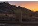 Desert landscape behind a metal fence, with beautiful sunset colors in the sky at 20436 N 17Th Pl, Phoenix, AZ 85024