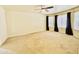 Spacious carpeted bedroom with a ceiling fan and ample natural light at 20436 N 17Th Pl, Phoenix, AZ 85024