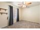 Simple carpeted bedroom with ceiling fan, window and ample space at 20436 N 17Th Pl, Phoenix, AZ 85024