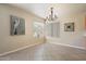 Bright dining room with tile flooring, large windows, and a modern chandelier at 20436 N 17Th Pl, Phoenix, AZ 85024