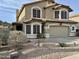 Two-story house with tan exterior, landscaped yard, and attached garage at 20436 N 17Th Pl, Phoenix, AZ 85024