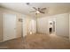 Spacious main bedroom with soft carpet, ceiling fan, and multiple doorways at 20436 N 17Th Pl, Phoenix, AZ 85024