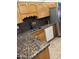 Kitchen with granite countertops and wood cabinets at 3325 W Belmont Ave, Phoenix, AZ 85051