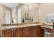 Elegant bathroom with double vanity, granite counters, and large mirror at 34704 N 93Rd Pl, Scottsdale, AZ 85262