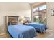 Bright bedroom with two twin beds and large window at 34704 N 93Rd Pl, Scottsdale, AZ 85262