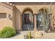 Wrought-iron entry gates with a southwestern design, leading to the house at 34704 N 93Rd Pl, Scottsdale, AZ 85262