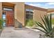 Front entry with wooden door, stone pathway, and desert landscaping at 34704 N 93Rd Pl, Scottsdale, AZ 85262