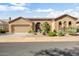 Single-story home with desert landscaping, two-car garage, and gated entry at 34704 N 93Rd Pl, Scottsdale, AZ 85262