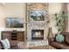 Cozy stone fireplace with built-in shelving and mantle at 34704 N 93Rd Pl, Scottsdale, AZ 85262