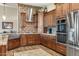 Spacious kitchen with dark wood cabinets, granite countertops, and a stylish backsplash at 34704 N 93Rd Pl, Scottsdale, AZ 85262