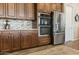 Modern kitchen with stainless steel appliances and dark wood cabinetry at 34704 N 93Rd Pl, Scottsdale, AZ 85262