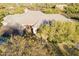 Aerial view of luxury desert home with tile roof nestled among mature trees at 37615 N Tranquil Trl, Carefree, AZ 85377