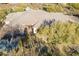 Aerial view of luxury tile roof desert home with lush surroundings and desert flora at 37615 N Tranquil Trl, Carefree, AZ 85377