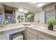 Bright bathroom featuring a plant accent, vanity with sink, and well-lit mirrors at 37615 N Tranquil Trl, Carefree, AZ 85377