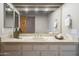 Bathroom featuring a vanity with neutral countertops, large mirror, and decorative accents at 37615 N Tranquil Trl, Carefree, AZ 85377