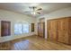 Bedroom featuring light wood floors, a ceiling fan, a closet, and a storage cabinet at 37615 N Tranquil Trl, Carefree, AZ 85377